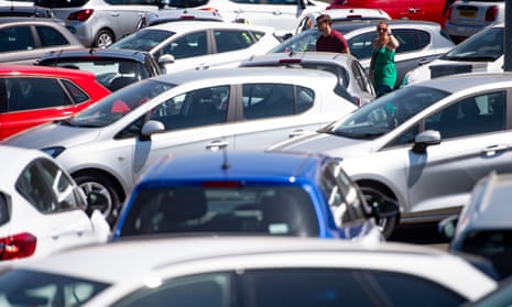 People viewing cars on the forecourt at a car showroom