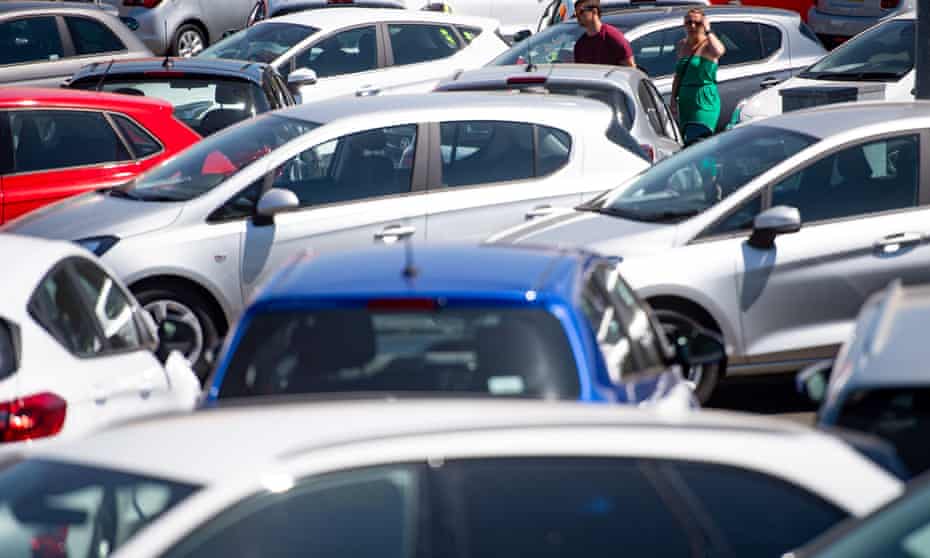 People viewing cars on the forecourt at a car showroom