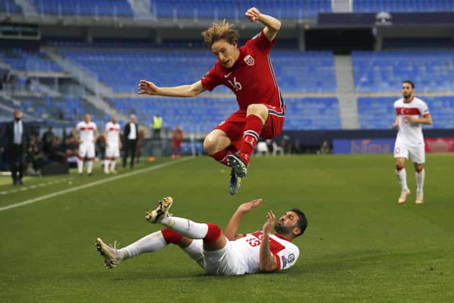 Turkey’s Umut Meras challenges Norway’s Jonas Svensson for the ball.