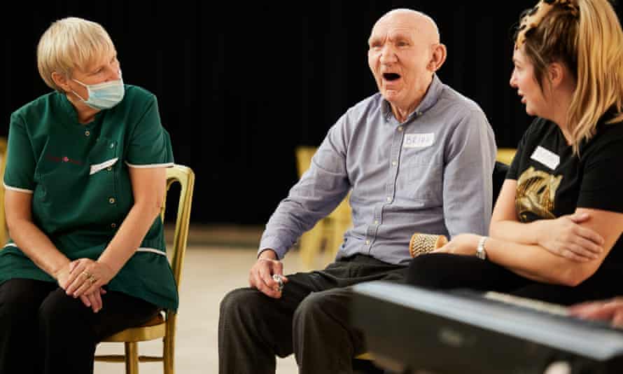 ‘Spiritual medicine’: orchestra helps people with dementia write music 3 A music cafe participant and a carer taking part