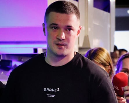A man in his 30s with short hair wearing a black T-shirt