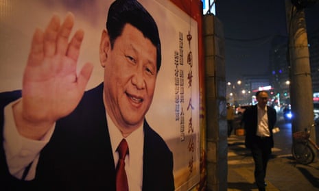 A man walks past a roadside poster of Chinese President Xi Jinping after the closing of the 19th Communist Party Congress in Beijing.
