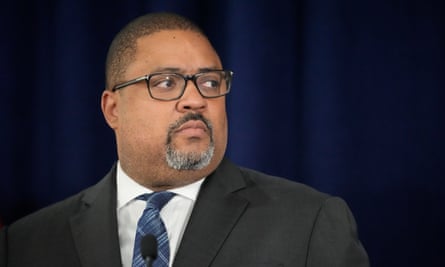 A rotund Black middle-aged man with very short hair and a salt-and-pepper goatee, and black-framed glasses, wearing a dark gray suit and looking to his left.