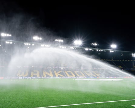 The grass is watered before a match