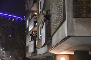 People applaud from flats by St. Thomas’ hospital in south-east London