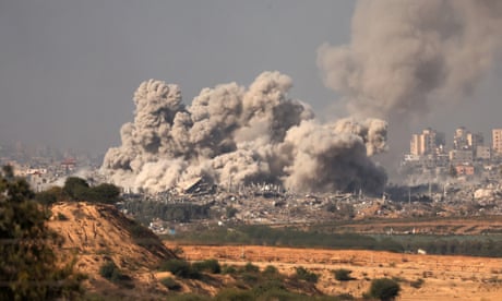 Destroyed buildings lie below smoke rising after an explosion in the northern Gaza Strip