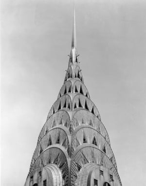 View of the crown and spire of the Chrysler building, with its arches, triangular windows, and steel cladding, New York, mid-20th century