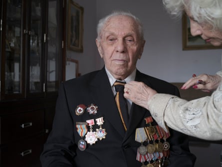 A Red Army veteran wearing a jacket covered in medals and a tie