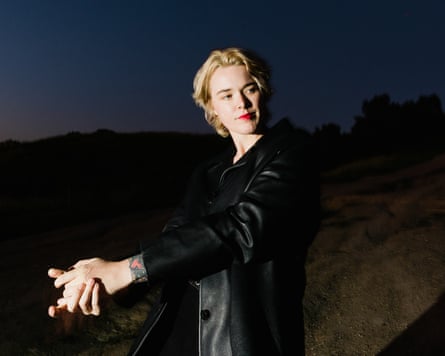 Wedl looking over her shoulder, in a black leather jacket