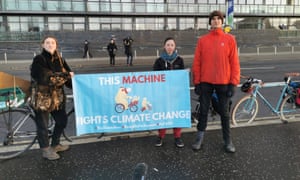 Cyclists channelling Woody Guthrie protest in front of the Cop26 gates in Glasgow