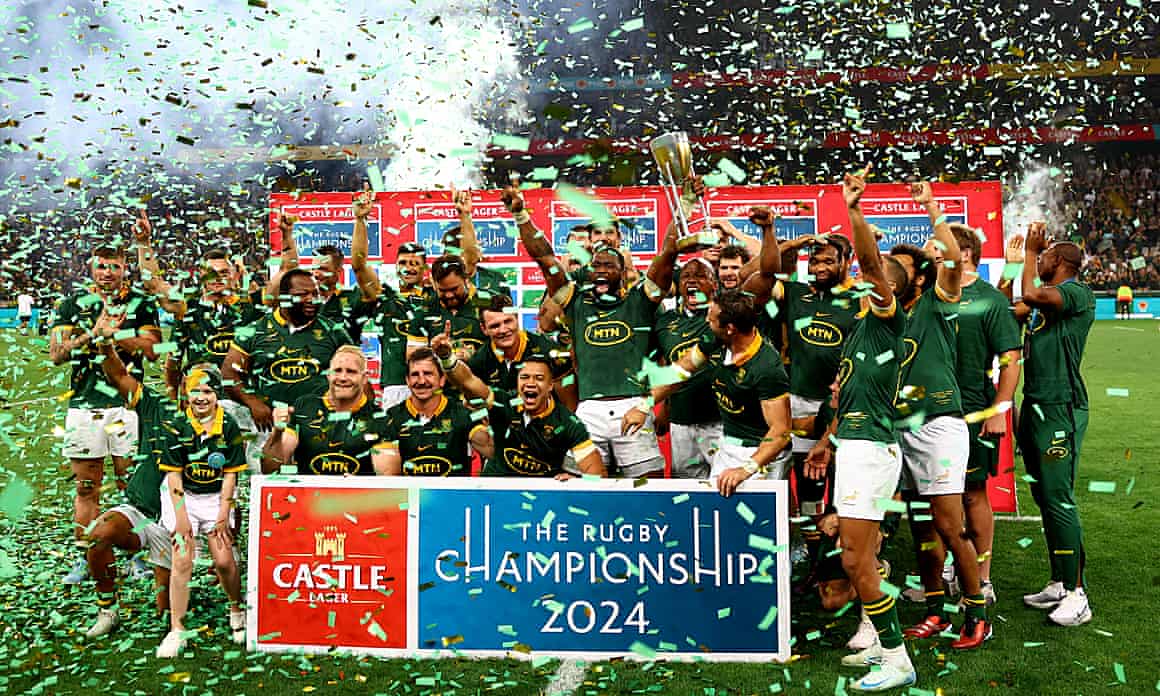 South Africa's Siya Kolisi celebrates with the trophy and teammates after winning the Rugby Championship