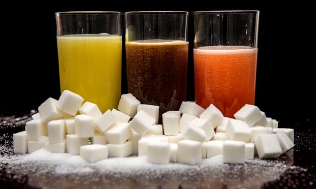 Fizzy drinks behind a pile of sugar cubes