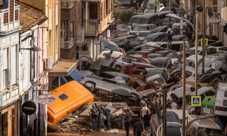 Cars piled in the street after flash floods hit the Sedaví area of Valencia, Spain.