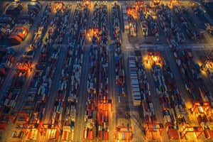Hundreds of containers of different colours in rows, photographed from above