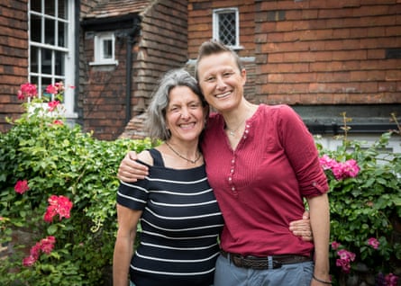 The couple with their arms around each other in a garden