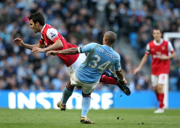 This is how Manchester City fans may remember Nigel de Jong, seen here tackling Cesc Fabregas.