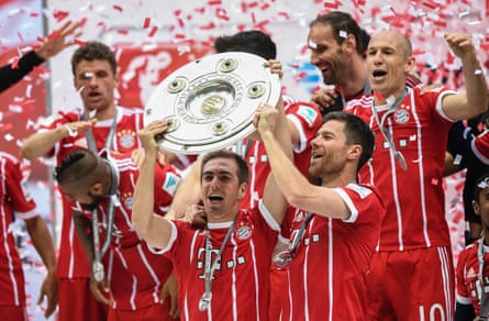 Philipp Lahm and Xabi Alonso lift the 2017 Bundesliga trophy together at Bayern Munich
