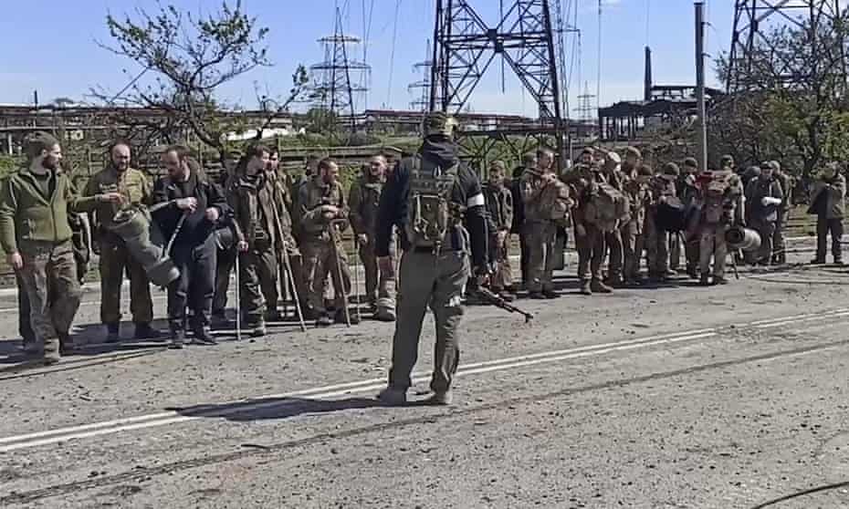 Ukrainian servicemen guarded by Russian troops after leaving the Azovstal steelworks in Mariupol