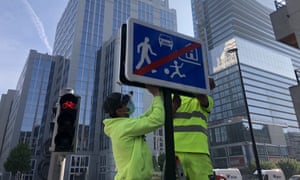 A road sign is installed in the city centre to indicate pedestrians and cyclists are the priority road users