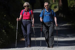 Theresa May walks in a forest with her husband Philip at the start of a summer holiday in the Alps.