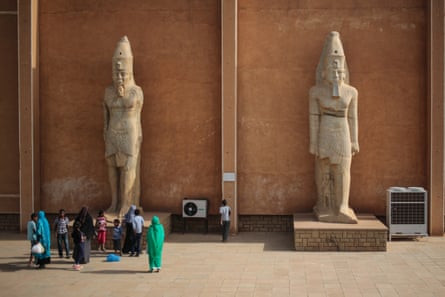 A group of people standing at the foot of a monumental statues