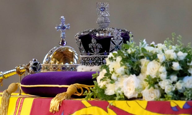 The coffin of Queen Elizabeth II, draped in the Royal Standard with the Imperial State Crown and the Sovereign's Orb and Sceptre.