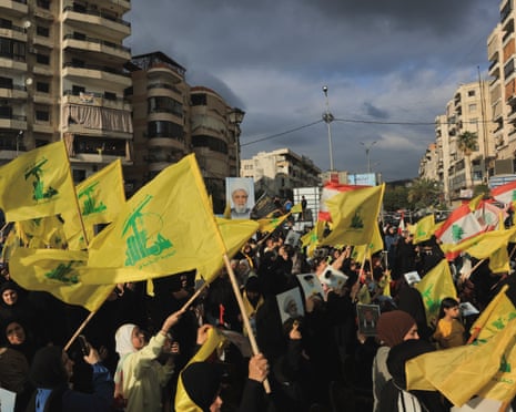 People hold Hezbollah flags while commemorating Israel’s withdrawal from southern Lebanon in 2000, in the southern suburbs of Beirut.