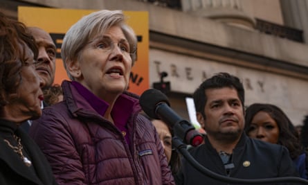 a woman speaks surrounded by other people outside the treasury building
