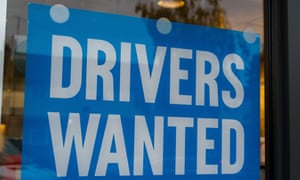 A drivers wanted sign in a pizza takeaway window in Windsor