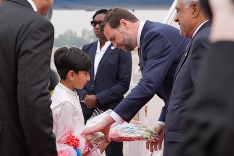 JD Vance receives a bouquet of flowers from a young boy after stepping off Air Force Two.