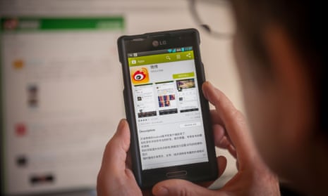 A woman prepares to load the Weibo app on her smartphone.
