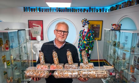 Jason Alexander in his Vintage Litter Museum with a boat display made from some of the cigarette butts he has picked up.