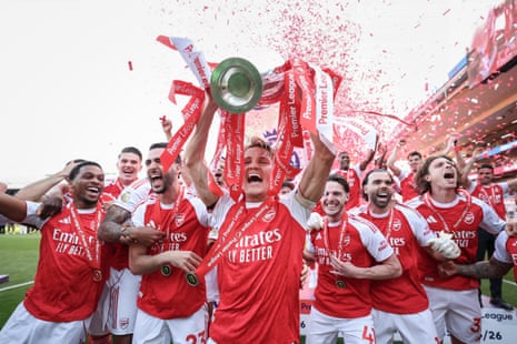 Martin Ødegaard lifts the Premier League trophy for Arsenal.