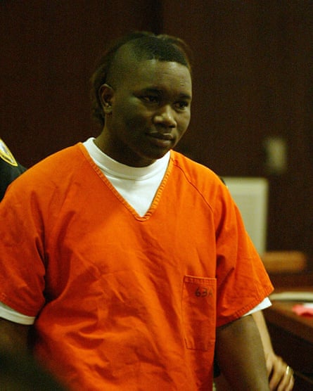 a man in orange prison clothing