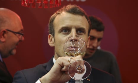 French president Emmanuel Macron tasting wine at an agricultural fair in 2018.