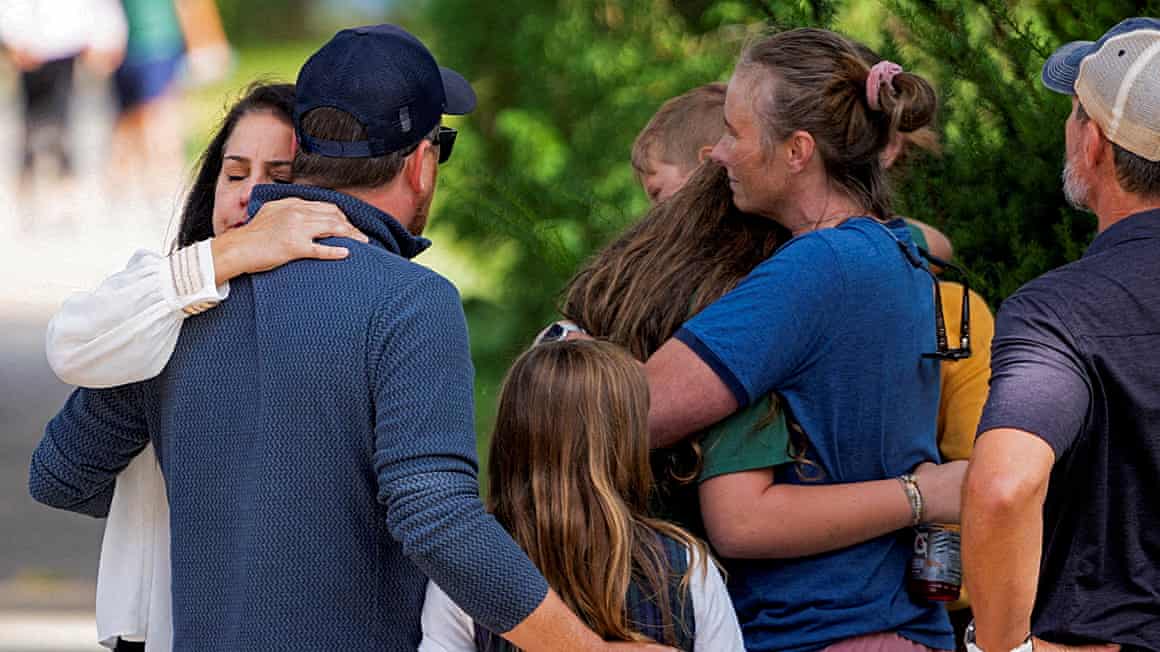 Families and loved ones reunite outside the police barricades after a shooting at Annunciation Church, which is also home to an elementary school.