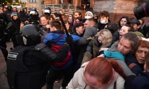Police officers detain demonstrators in St Petersburg
