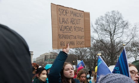 sign says stop making laws about women's bodies reproductive rights are human rights