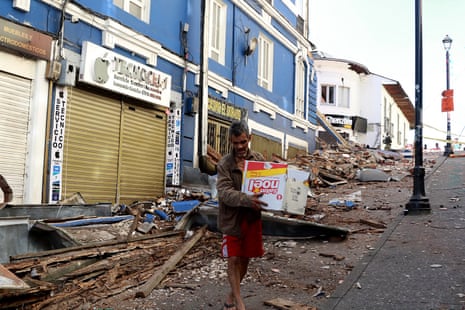 A man walks amid debris of a damaged commercial store after the earthquake in Manizales, Colombia, on August 10, 2026.