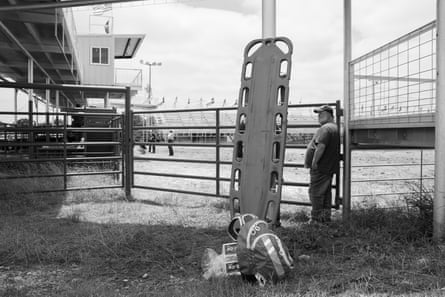 A man stands adjacent to an upright stretcher