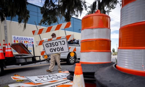 Chatham County Public Works employee Richard McCoy puts barrels, cones and road closure signs out for the police department in preparation for Hurricane Idalia.