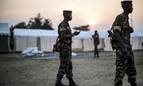 Soldiers patrol around marquees being built on the outskirts of Musaga, a neighbourhood in Bujumbura, on Monday. The marquees will be used as polling places.