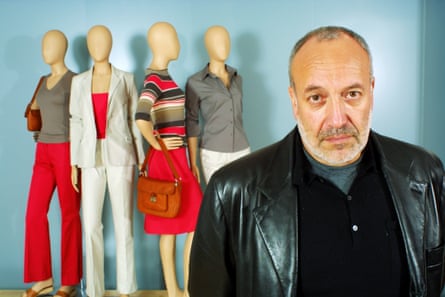A man standing in front of fashion mannequins