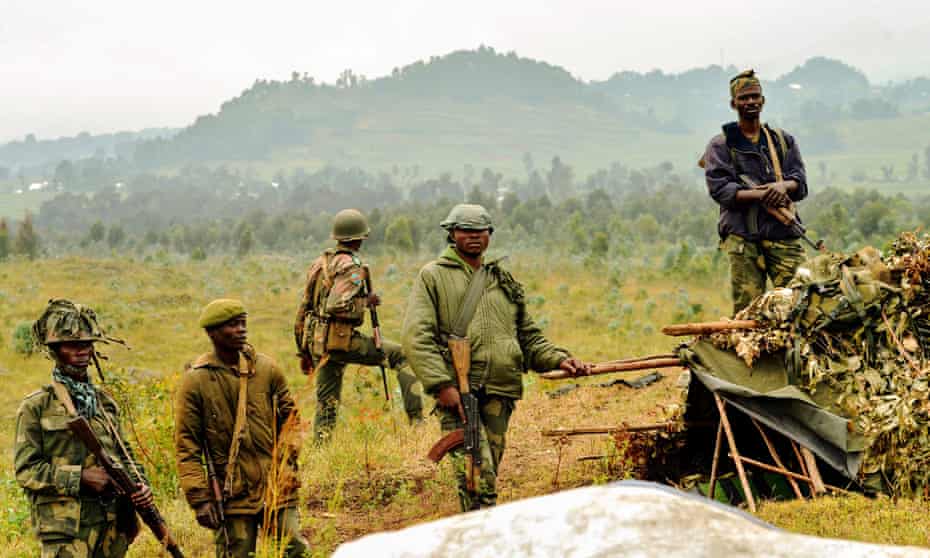 Democratic Republic of Congo soldiers stand guard near the border with Rwanda