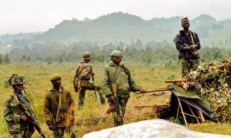 Soldiers of the Democratic Republic of the Congo stand guard near the border with Rwanda