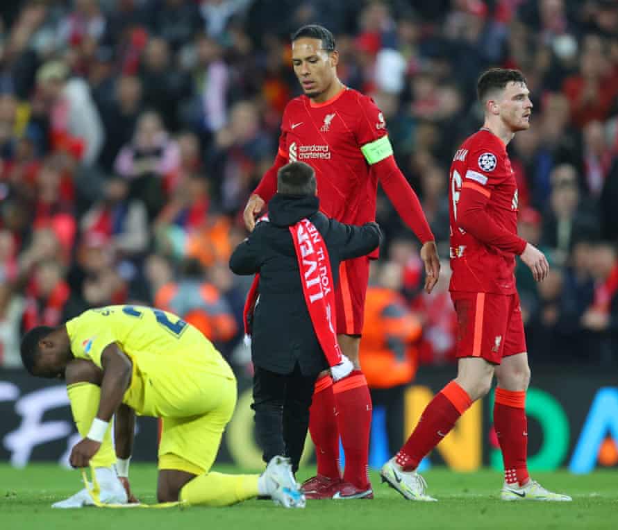 A young fan goes to embrace Virgil van Dijk after the final whistle.