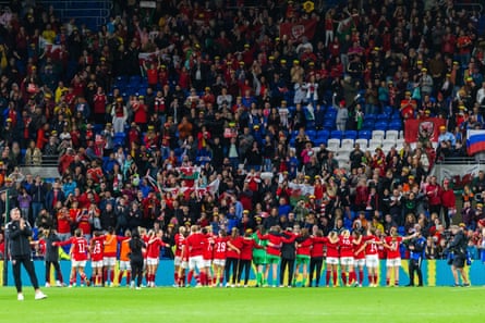 The Wales players celebrate with their fans at the Cardiff City Stadium after qualifying for the 2023 Women’s World Cup playoffs.