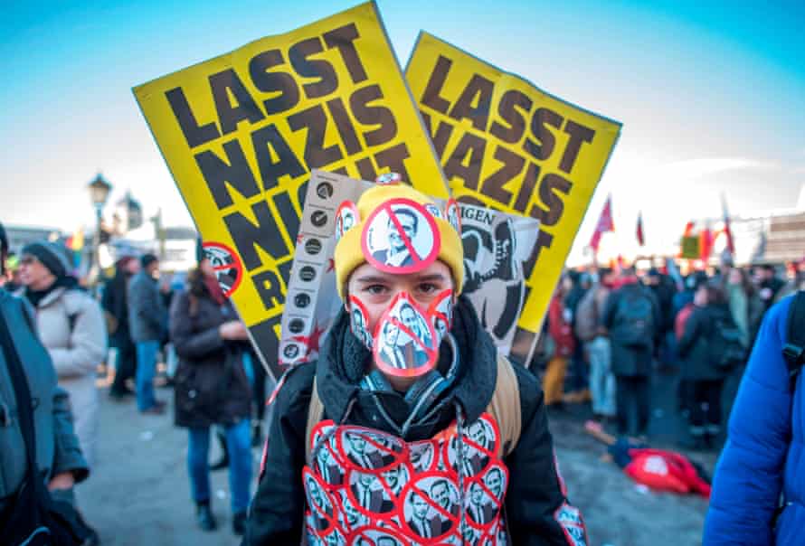 A protester with stickers depicting the new vice-chancellor of the far-right Freedom Party Christian Strache and incoming Austrian chancellor of the conservative People’s Party Sebastian Kurz in Vienna last December.