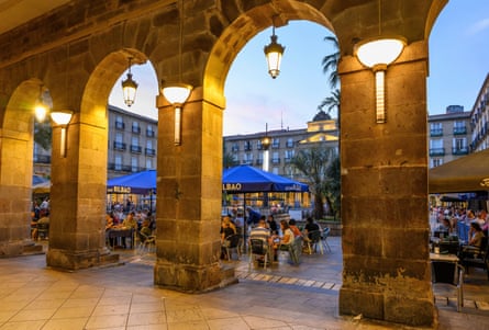 Arches and cafes in a square.