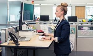 A standing desk is one of the ways firms can boost employees’ health.